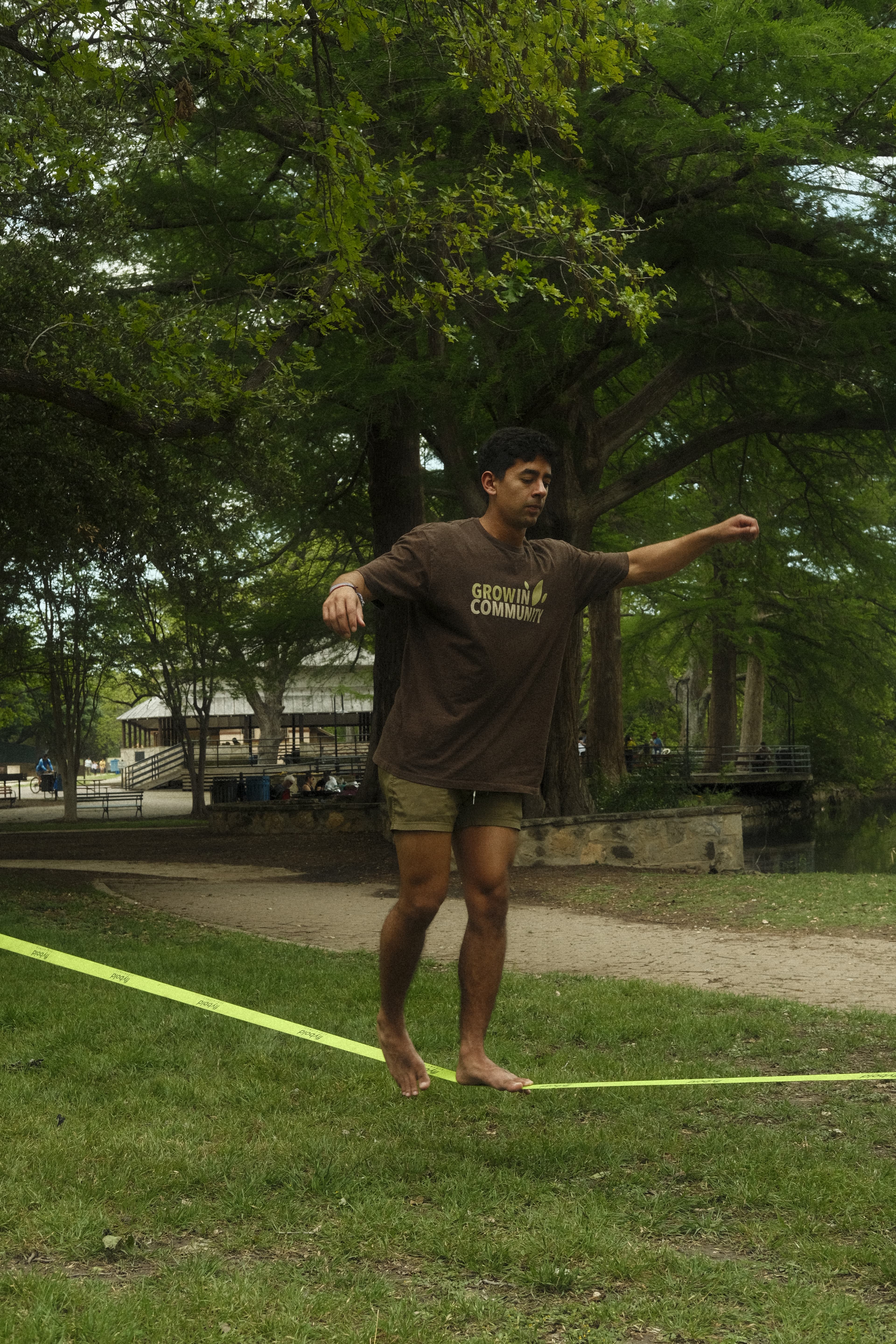 Slackline session under trees—balance and focus practice.